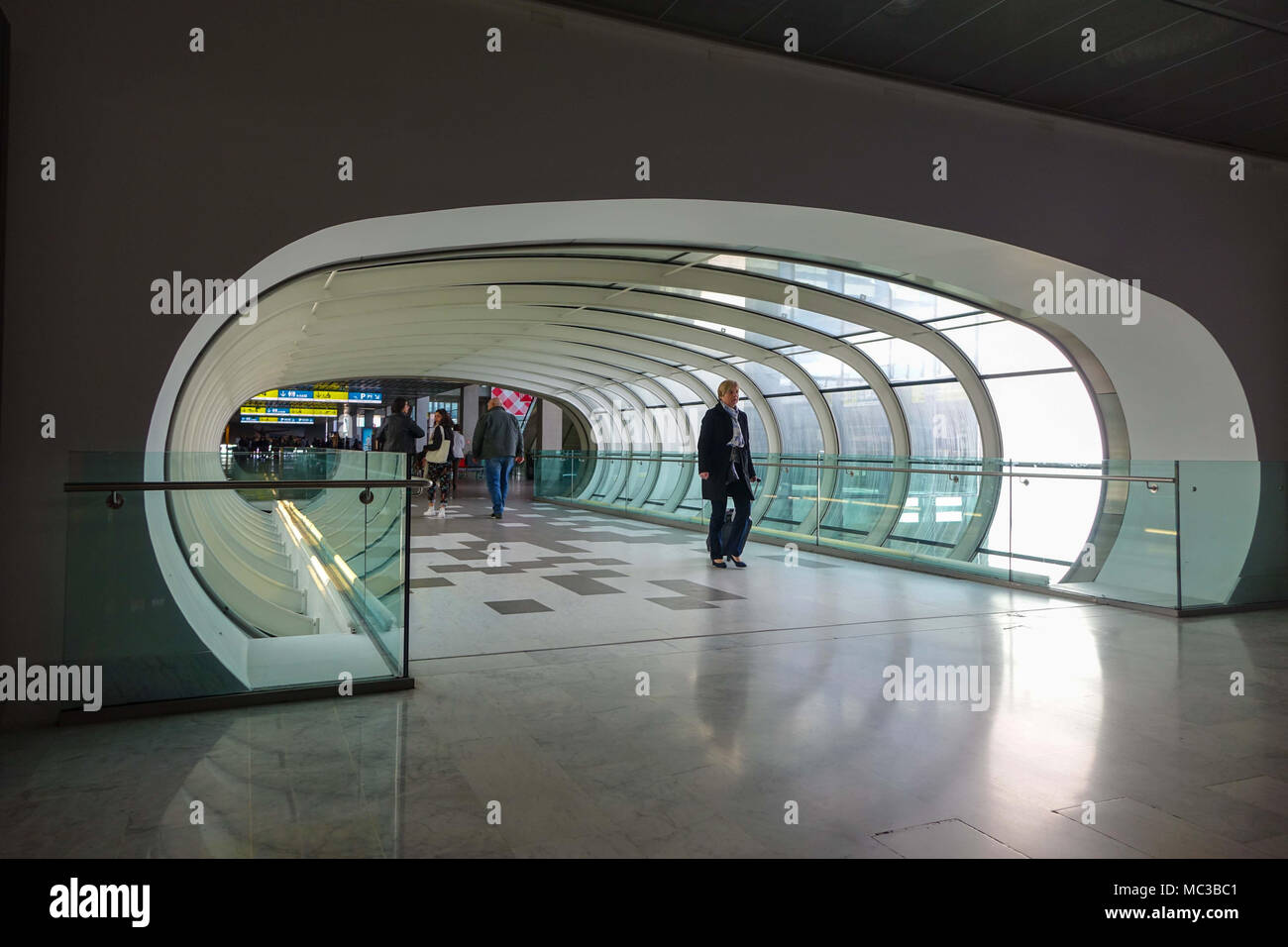 Pedestrian tunnel with people walking through, Toulouse Blagnac airport, France Stock Photo