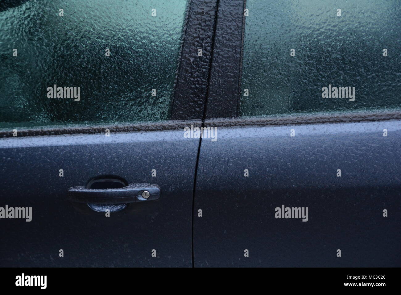 Frozen rain. Extreme weather. Danger for driving. Car locked. Stock Photo