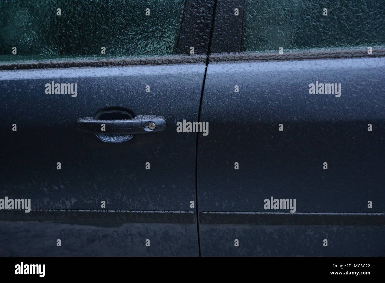 Frozen rain. Extreme weather. Danger for driving. Car locked. Stock Photo