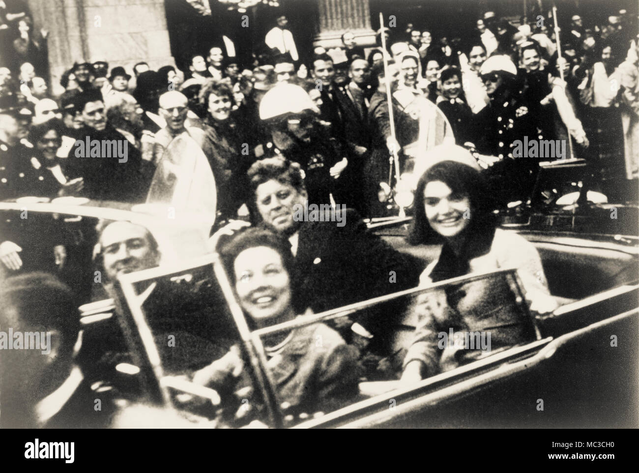 John F. Kennedy, Jacquelyn Kennedy, Texas Governor John Connally and Mrs. Connally in open top presidential limousine moments before the president's assasination in Dallas, Texas in November 1963. Stock Photo