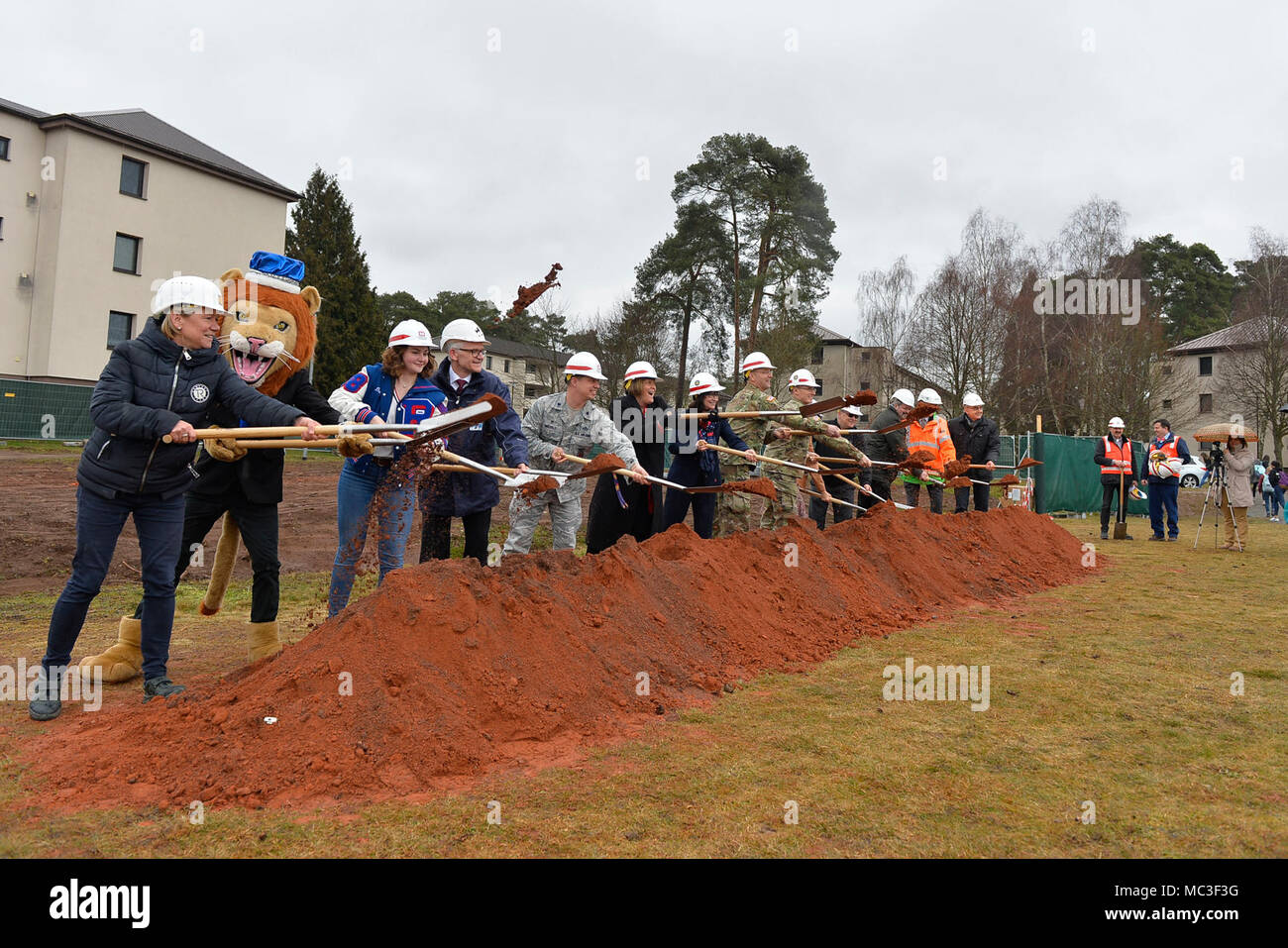 Military and civilian officials conduct a groundbreaking ceremony for a new school building on Ramstein Air Base, Germany, March 28, 2018. The Kaiserslautern Military Community has pushed to replace its old school buildings with futuristic 21st century educational facilities, which are characterized by student-centeredness, energy efficiency, and flexibility to accommodate multiple learning styles. Stock Photo