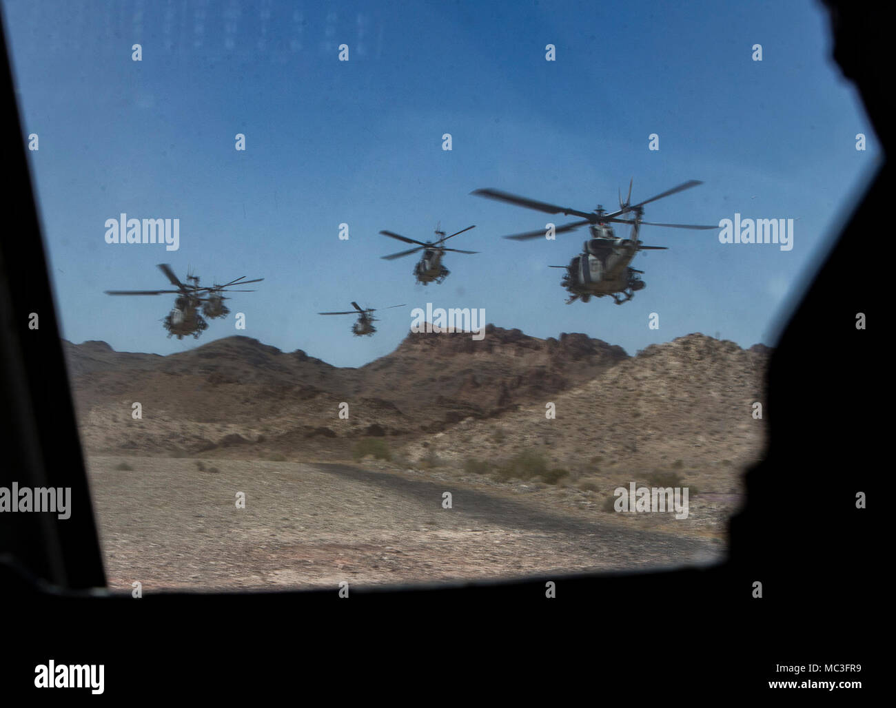 U.S. Marine Corps UH-1Y Venoms fly in formation for an attack pass during Air to Ground Refinement in support of Weapons and Tactics Instructors course 2-18 at Marine Corps Air Station Yuma, Yuma, Ariz., April 2. WTI is a seven-week training event hosted by Marine Aviation Weapons and Tactics Squadron 1 cadre, which emphasizes operational integration of the six functions of Marine Corps aviation in support of a Marine Air Ground Task Force and provides standardized advanced tactical training and certification of unit instructor qualifications to support Marine Aviation Training and Readiness a Stock Photo