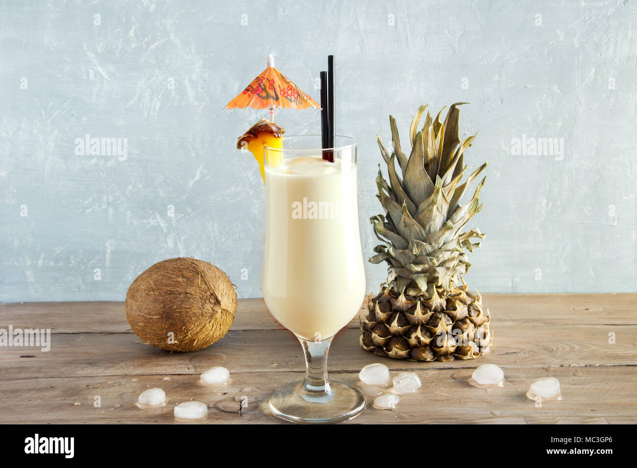 Pina Colada Cocktail with pineapple and coconut over wooden background, copy space. Summer tropical delicious cocktail. Stock Photo