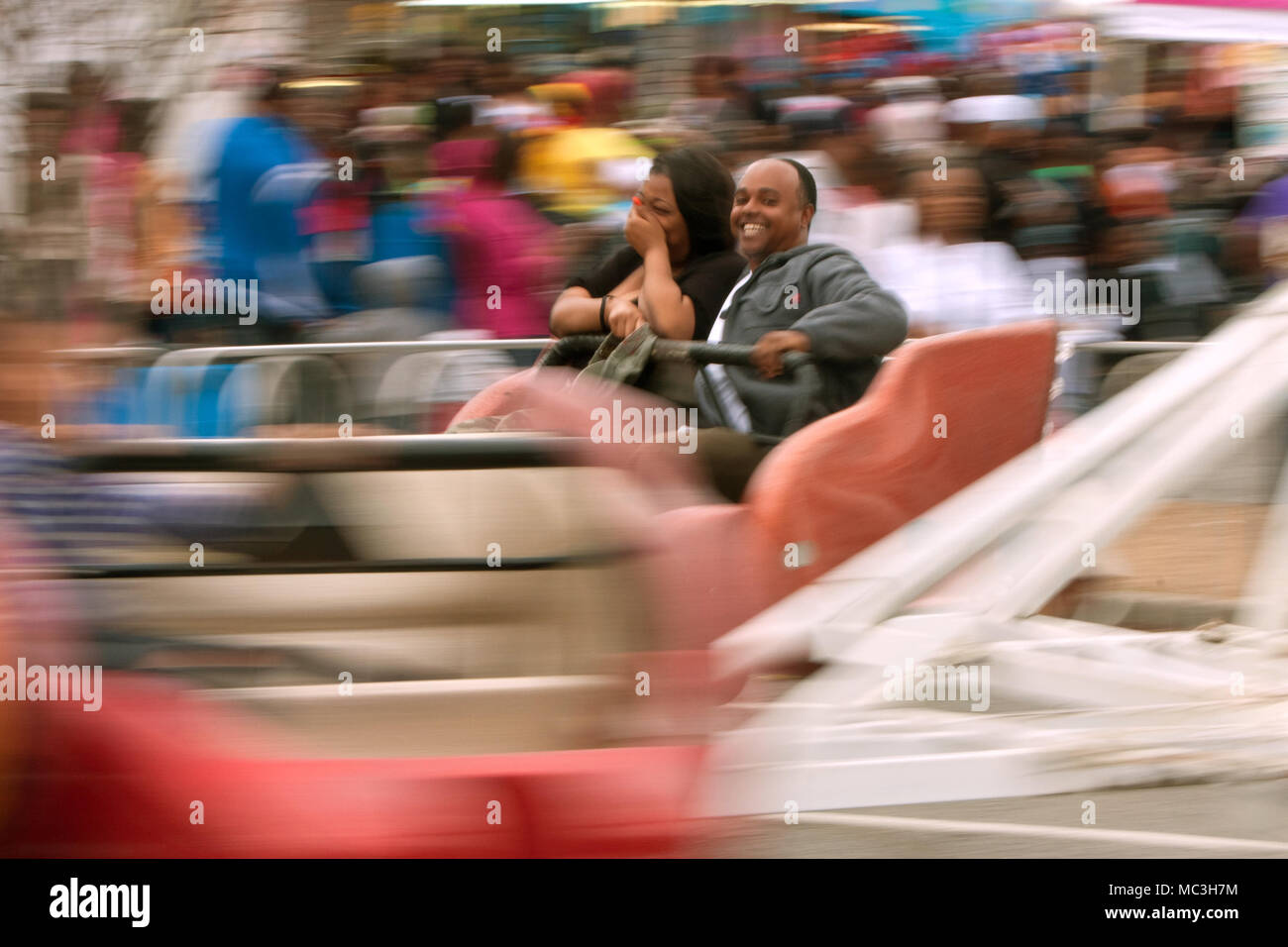 Atlanta, GA, USA - March 15, 2014: A couple laughs while riding a fast ...