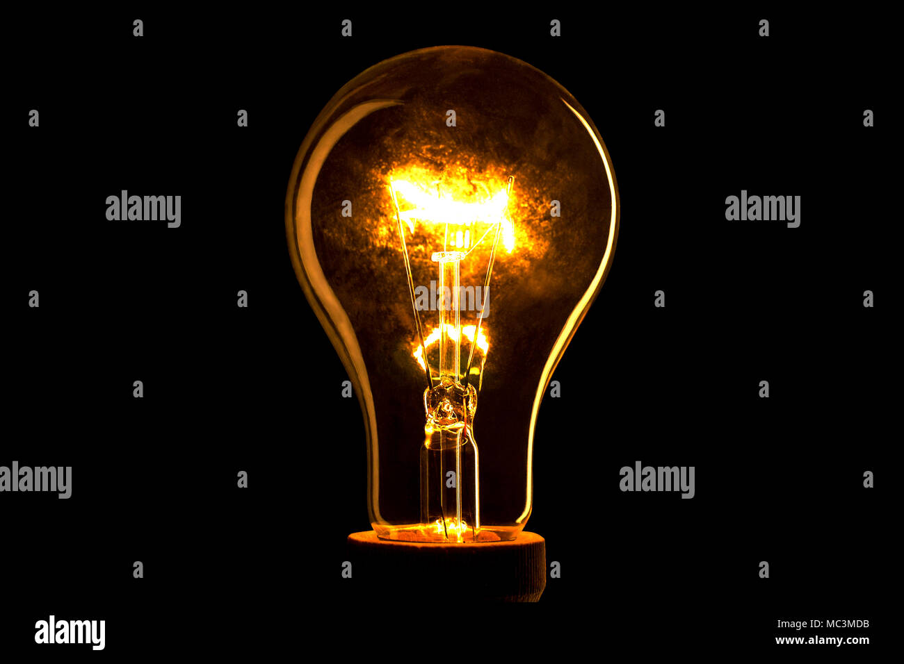Abstract light bulb on the black background. Lamp light in the dark.  Electric bulb. Glowing light in the dark Stock Photo - Alamy