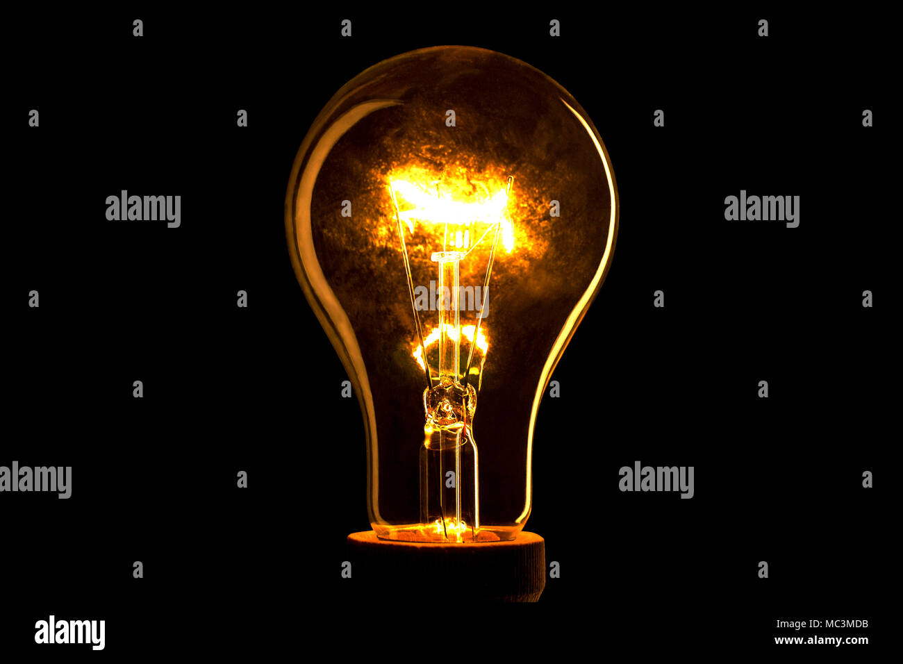 Abstract light bulb on the black background. Lamp light in the dark