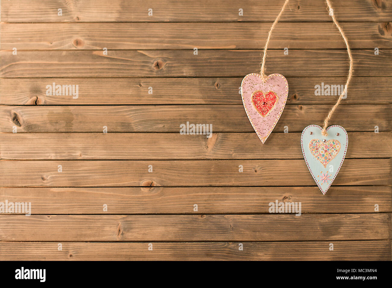 Handmade wooden heart on wooden background. Handmade love decoration. Wooden background with hearts Stock Photo