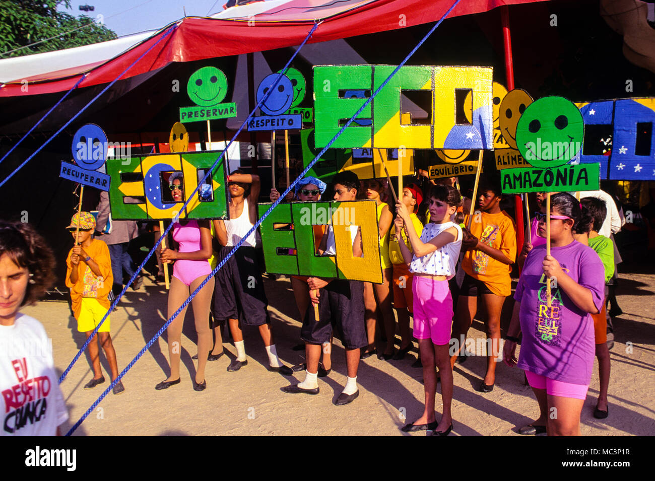 Street Children who are learning circus skills,displaying Eco Banners, at Global Forum, Flamingo Park, Rio, Brazil. Stock Photo