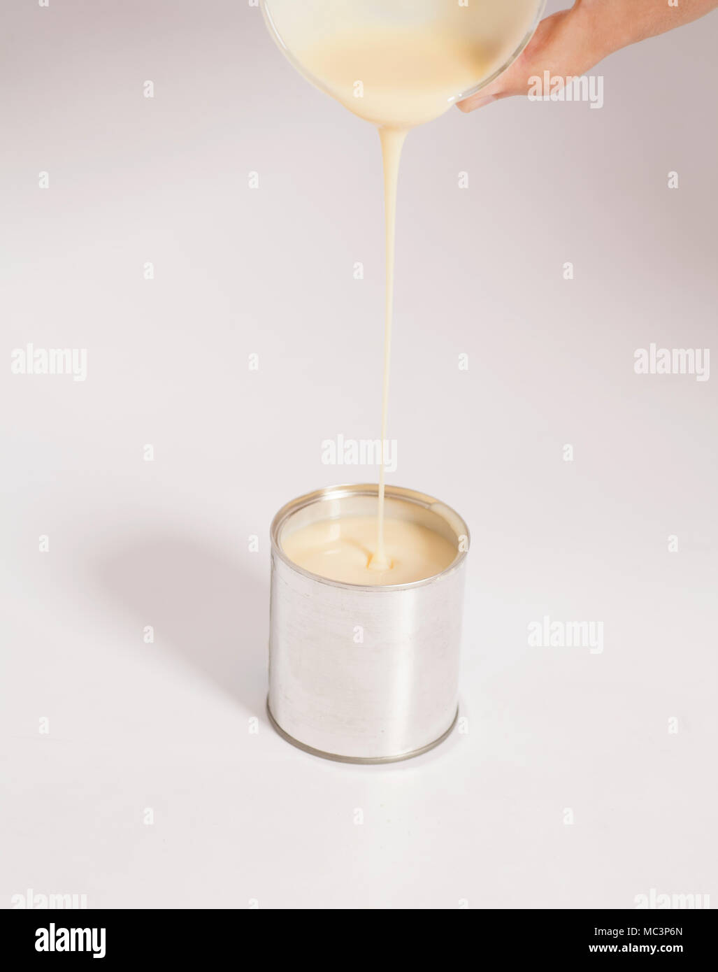 Hand pouring condensed milk hi-res stock photography and images - Alamy