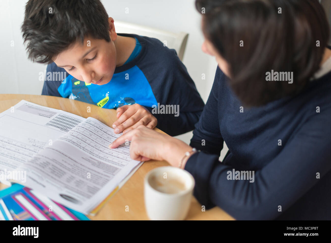 Private tutoring at home-10-11 years boy  having a maths lesson at home Stock Photo