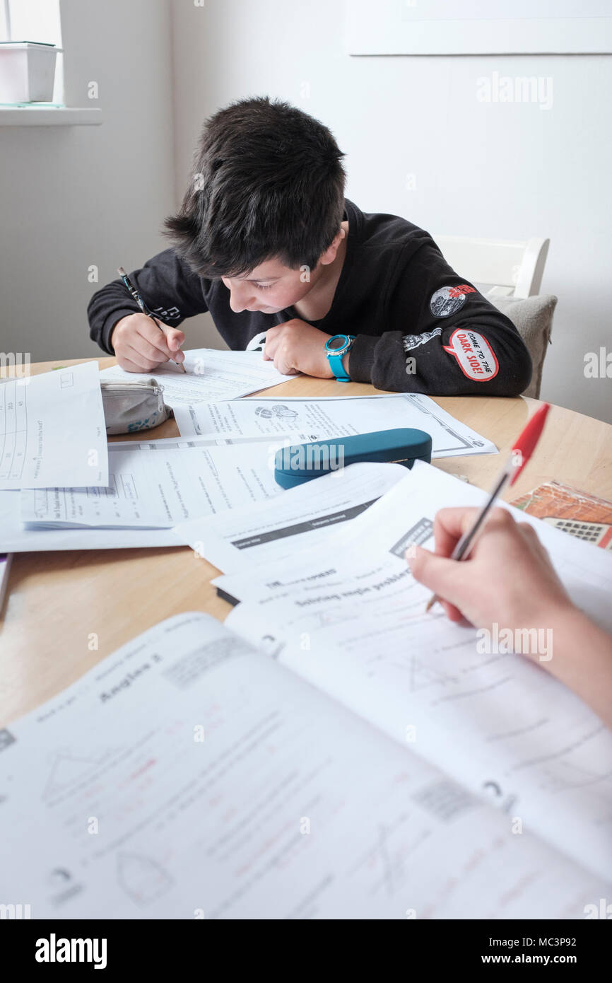 Children revising exams paper together Stock Photo