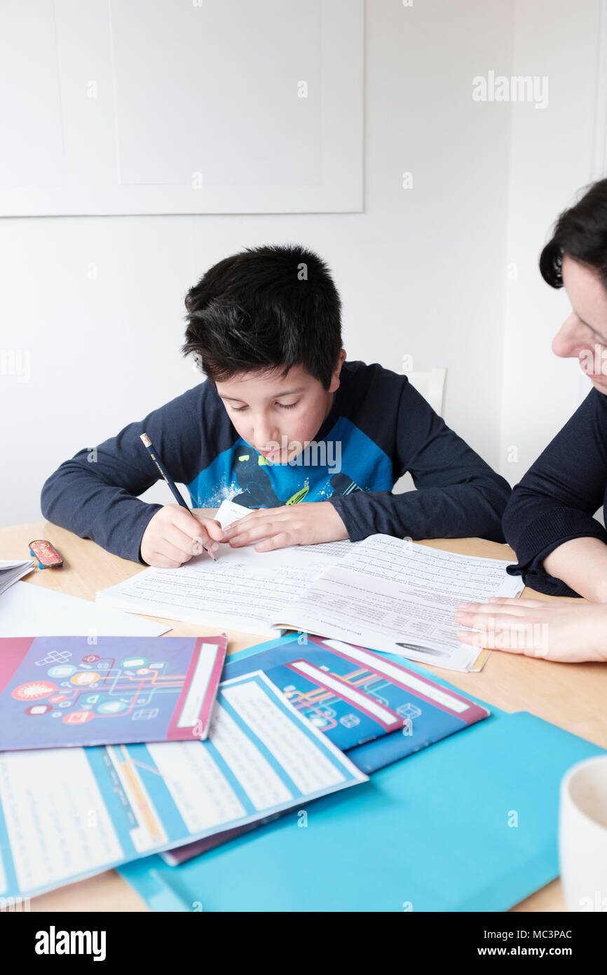 Private tutoring- 10 years old boy studies at home Stock Photo
