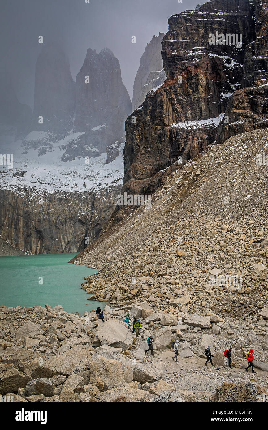 Hikers, in Mirador Base Las Torres. You can see the amazing Torres del Paine, Torres del Paine national park, Patagonia, Chile Stock Photo