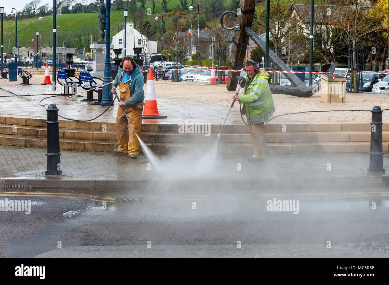 Two workmen power-washing the pavement in Bantry Square, Bantry, County Cork, Ireland. Stock Photo