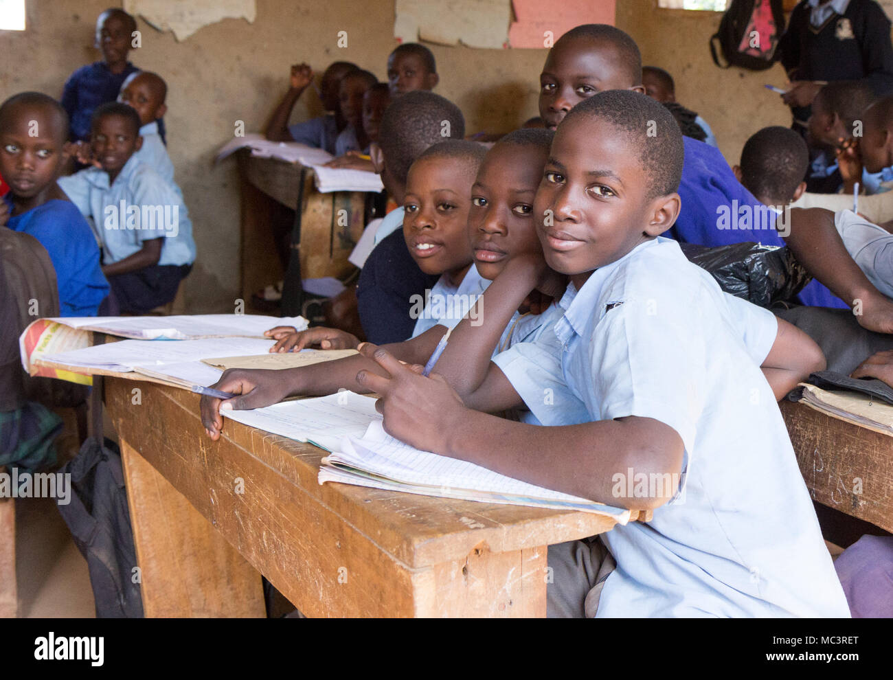 Uganda. June 13 2017. Smiling Ugandan children sitting at desks in a classroom in a primary school. Stock Photo
