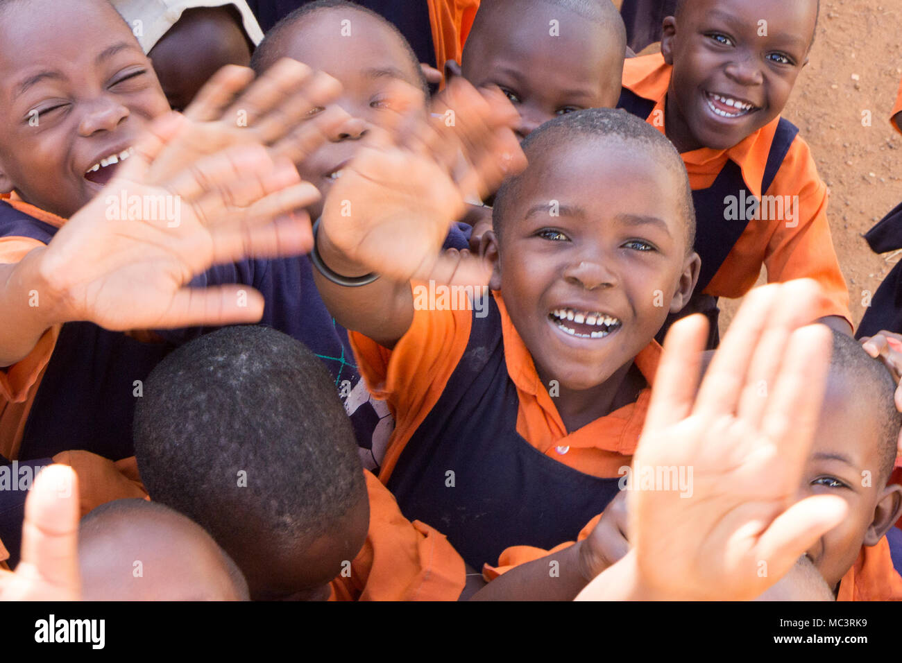 Uganda. June 13 2017. A group of happy primary-school children smiling, laughing and waving at a primary school. Stock Photo