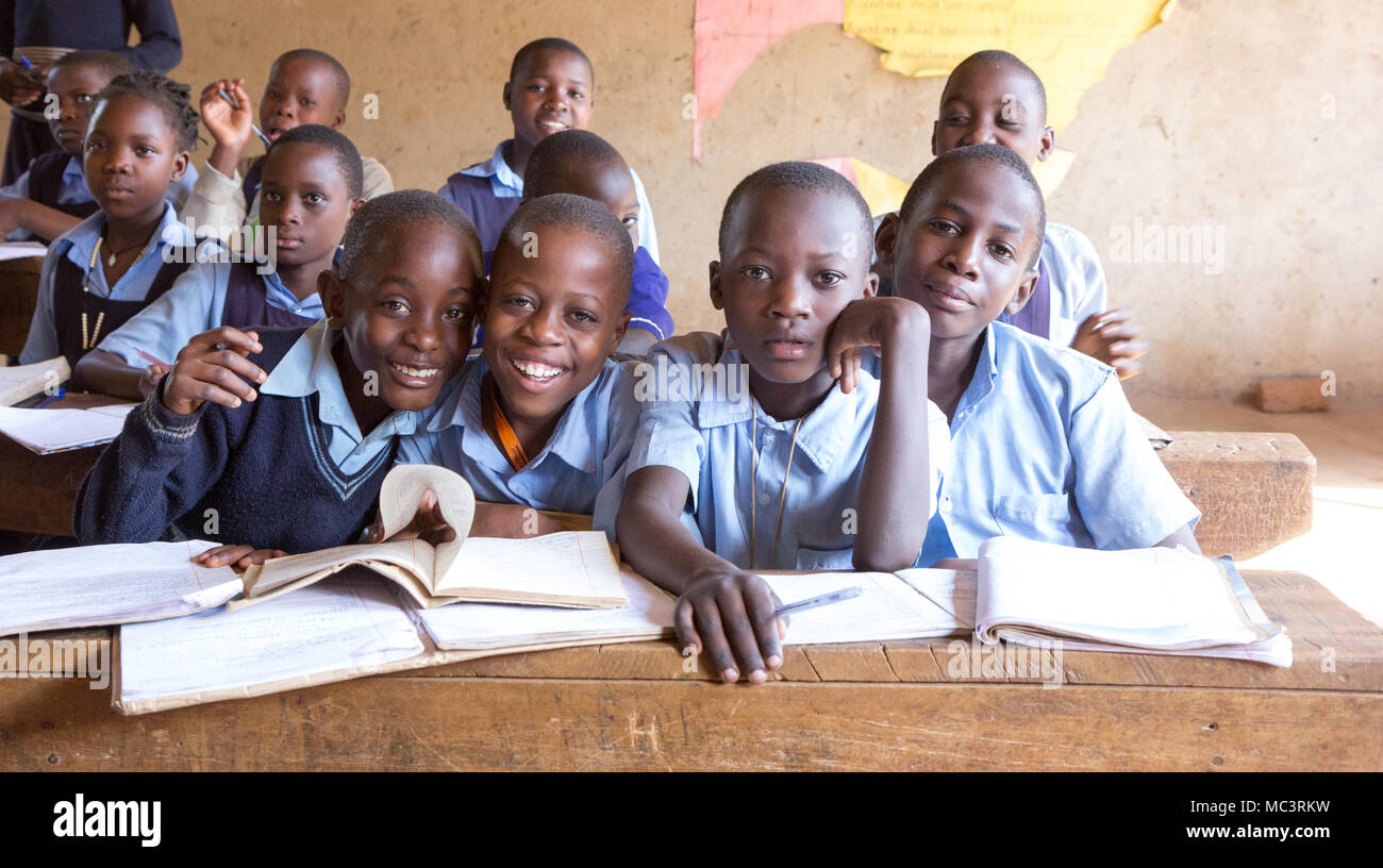 Uganda. June 13 2017. Smiling Ugandan children sitting at desks in a classroom in a primary school. Stock Photo