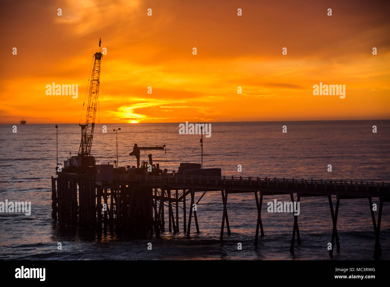 Sunset on oil dock Stock Photo Alamy