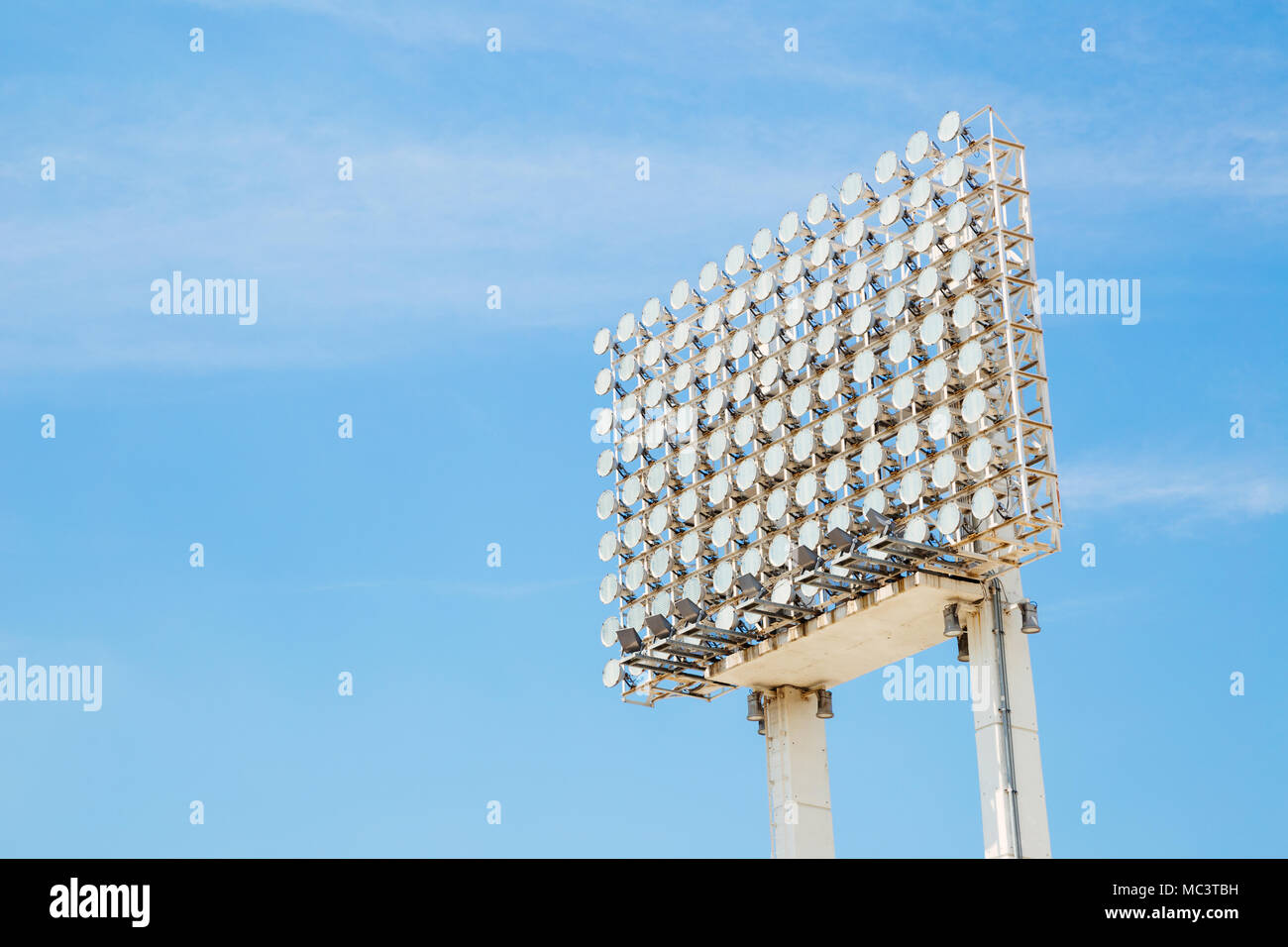 Stadium spotlight tower under blue sky Stock Photo Alamy