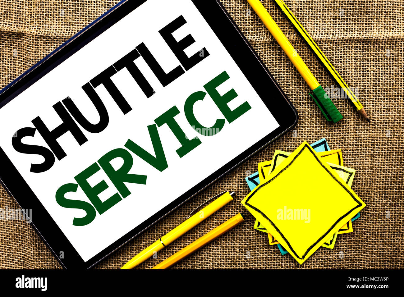 Text sign showing Shuttle Service. Conceptual photo Transportation Offer Vacational Travel Tourism Vehicle written Tablet the jute background Pens Pen Stock Photo