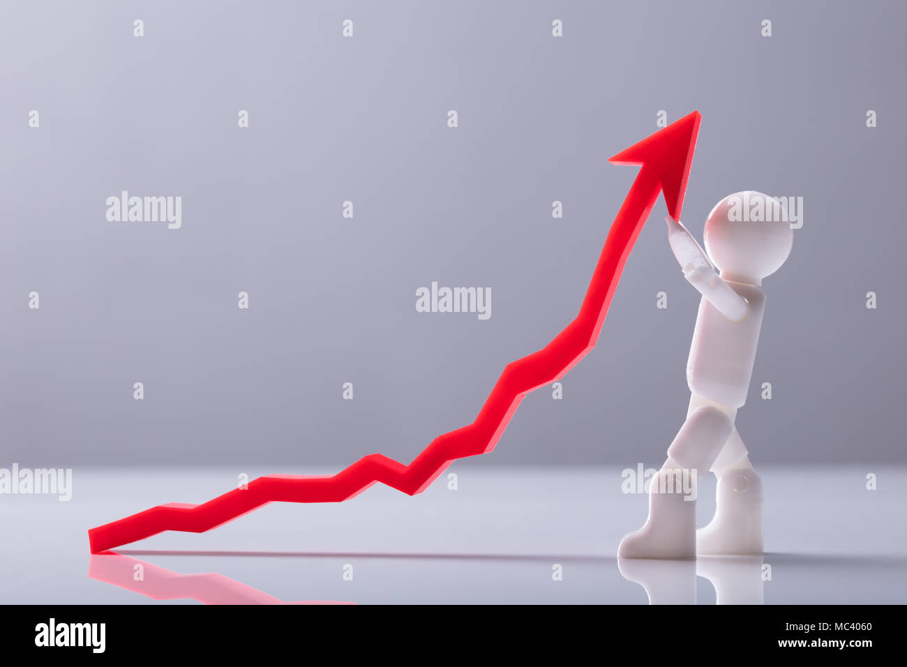 Side View Of A Human Figure Holding Red Arrow Symbol Showing Upward Direction Stock Photo