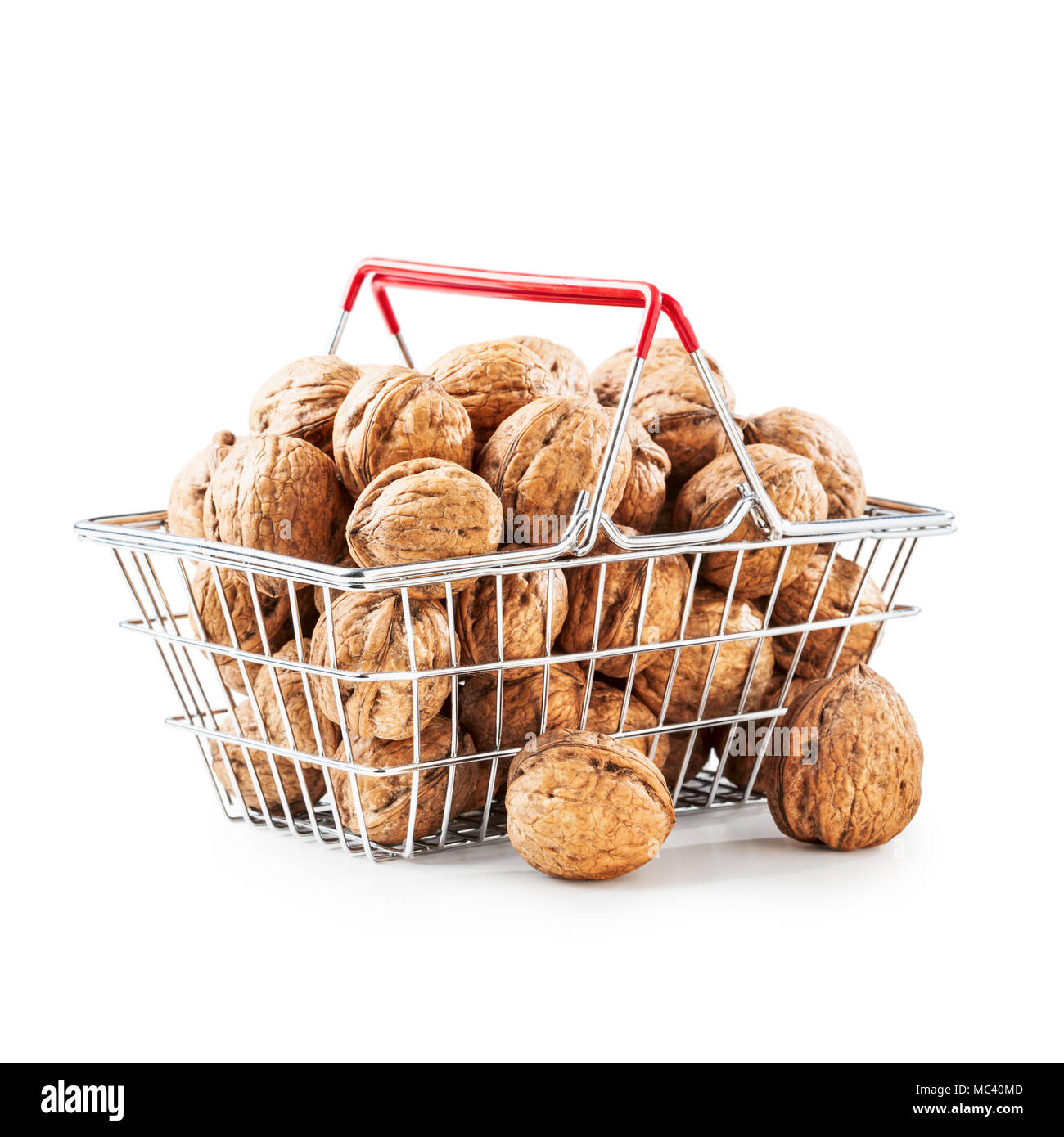 Walnuts in shopping basket, unpeeled walnut heap as healthy eating and dieting concept, objects group isolated on white background clipping path inclu Stock Photo