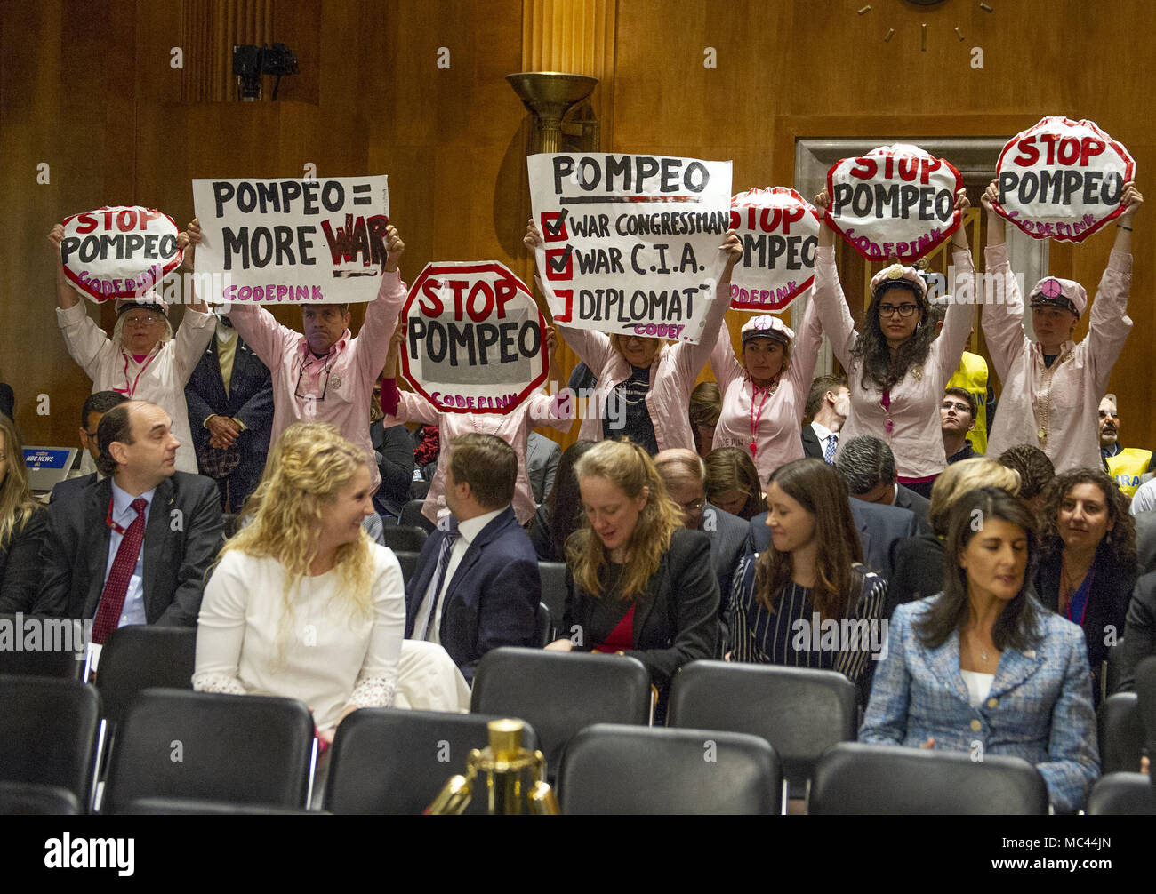 Washington, District of Columbia, USA. 12th Apr, 2018. Protestors hold up signs prior to the arrival of CIA Director Mike Pompeo, who will testify on his nomination to be United States Secretary of State before the US Senate Committee on Foreign Relations on Capitol Hill in Washington, DC on Thursday, April 12, 2018.Credit: Ron Sachs/CNP Credit: Ron Sachs/CNP/ZUMA Wire/Alamy Live News Stock Photo