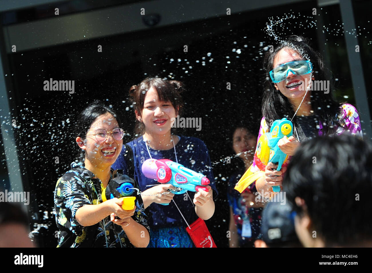 Bangkok, Thailand. 13th Apr, 2018. People take part in water gun battles during celebrations for Songkran Festival, Thailand's traditional New Year Festival, in Siam shopping district of Bangkok, Thailand, April 13, 2018. Credit: Rachen Sageamsak/Xinhua/Alamy Live News Stock Photo