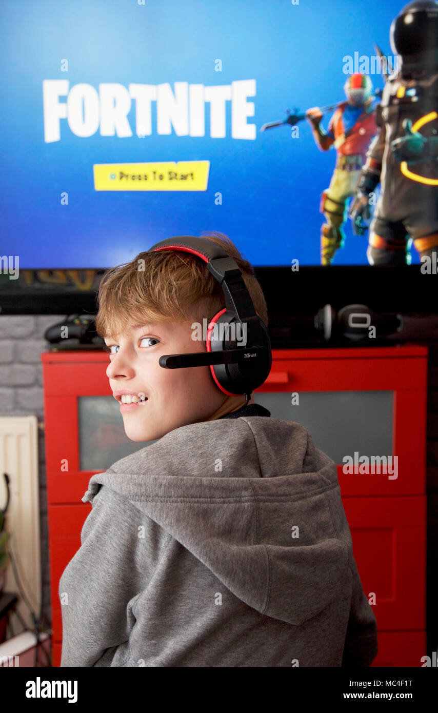 A boy plays Fortnite Battle Royale on his Xbox one Stock Photo