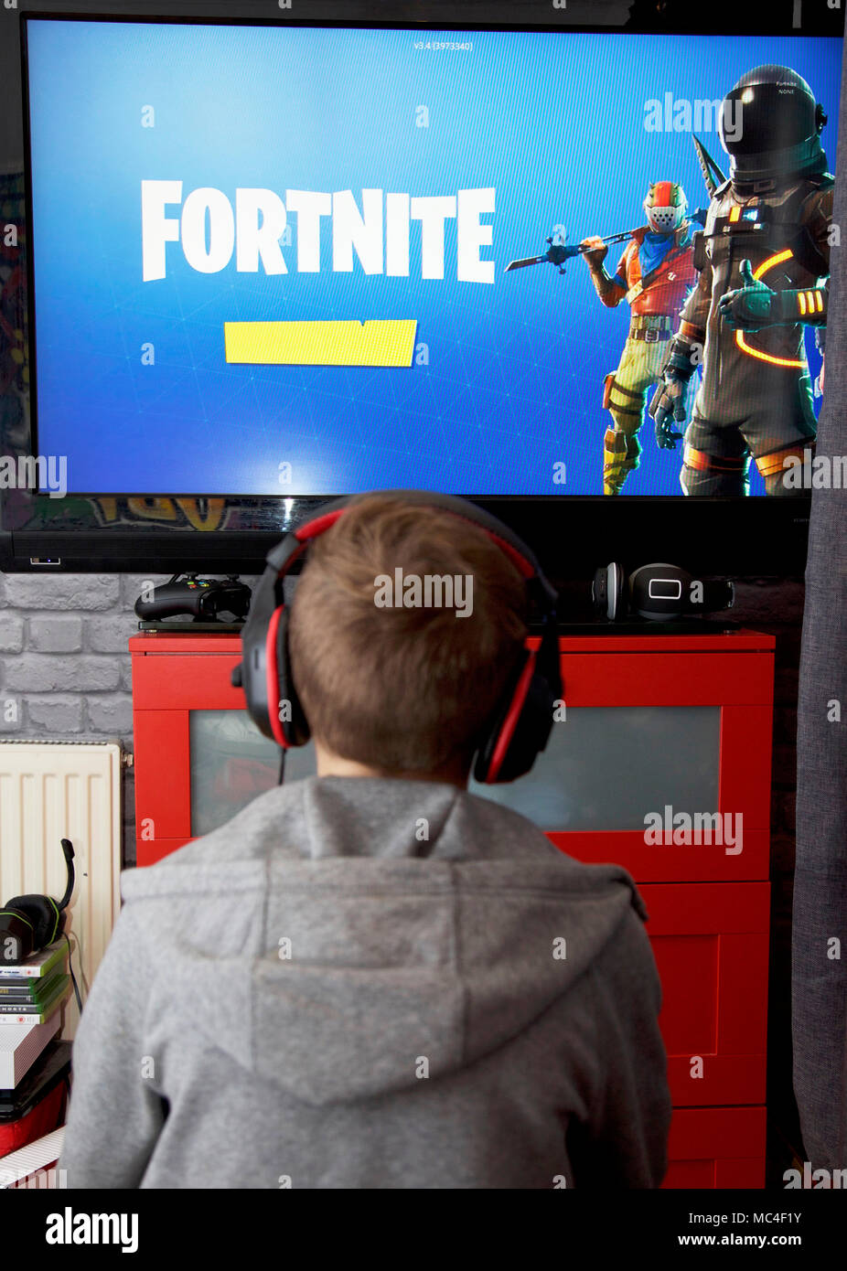 A boy plays Fortnite Battle Royale on his Xbox one Stock Photo