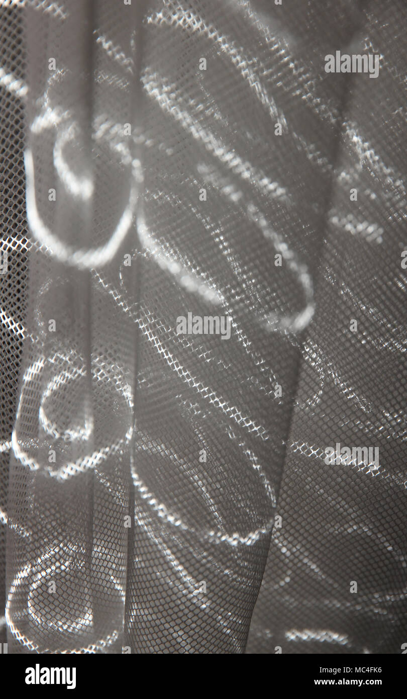 light beam on net curtain Stock Photo