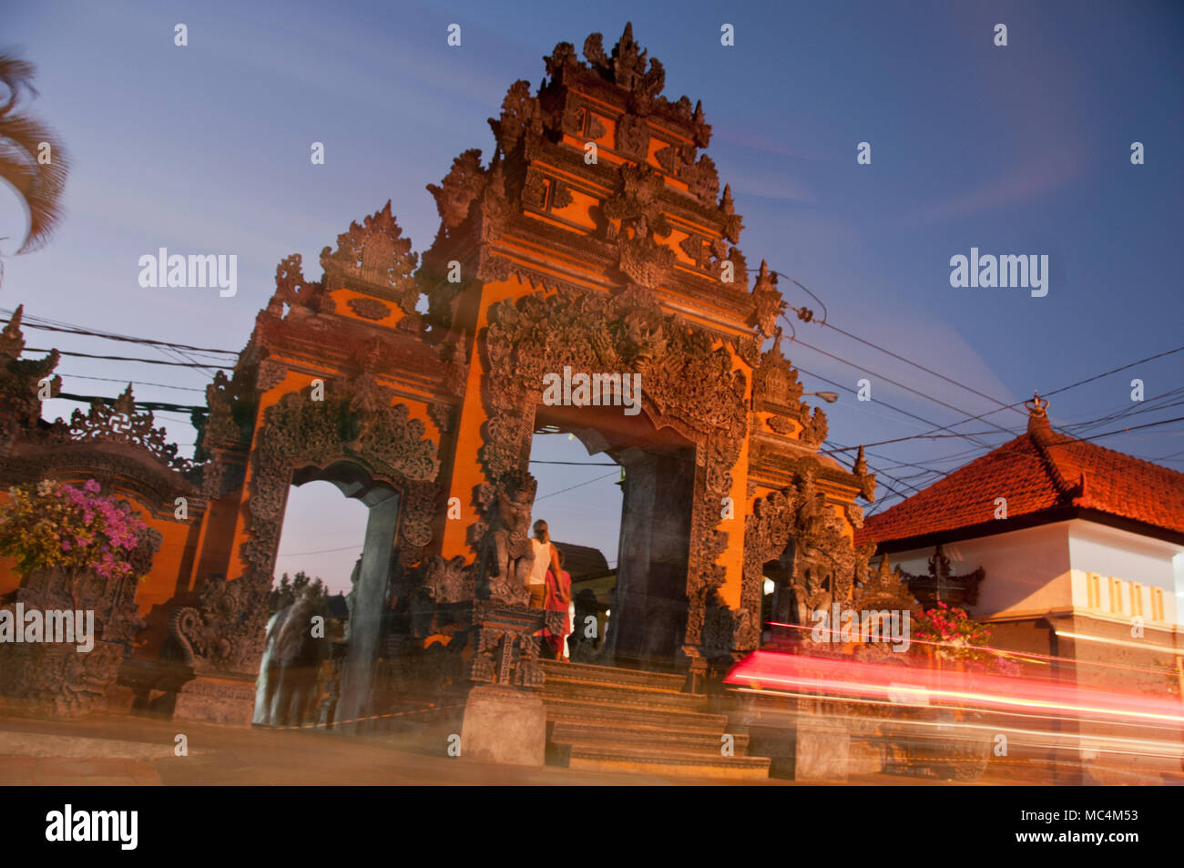 Traditional entrance gate of Tanah Lot beach in Bali with light movement Stock Photo