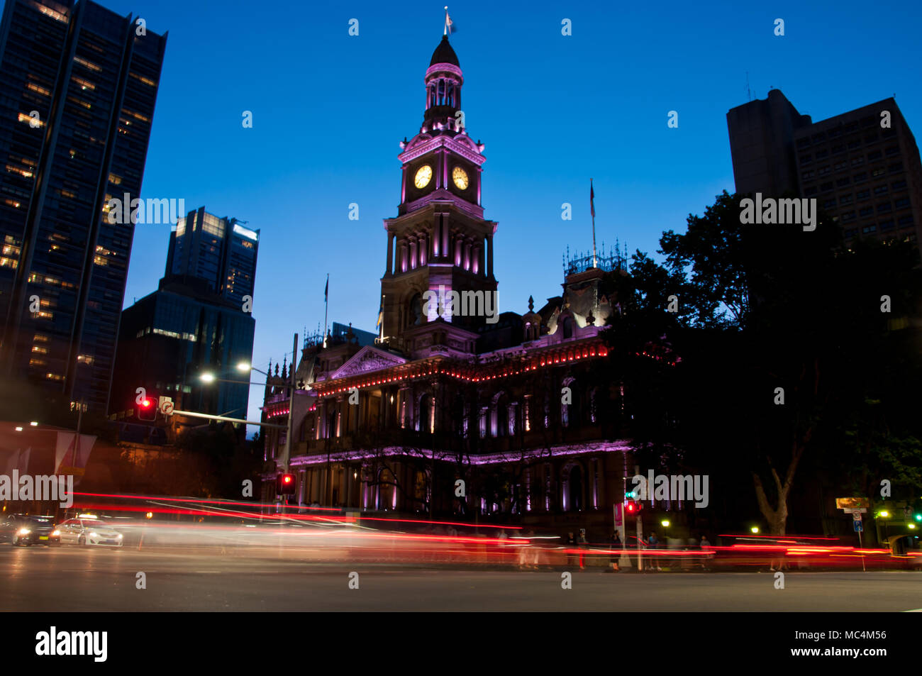 Light moving of bustling city center scene with old clock tower in Sydney Stock Photo