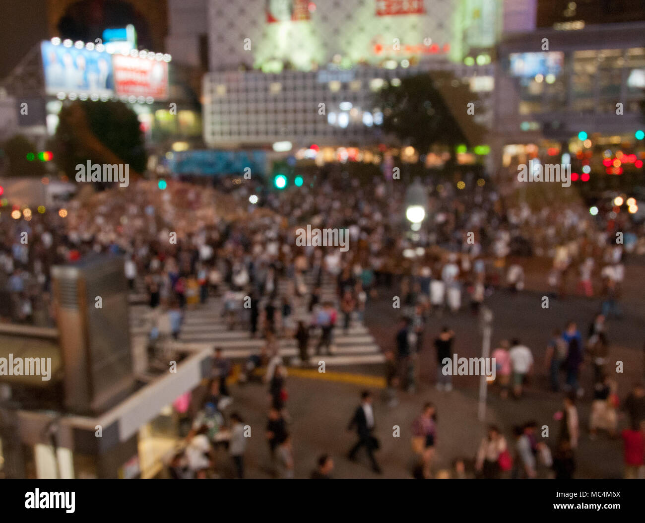 Defocused night scene of people crossing Shibuya intersection in Tokyo Japan Stock Photo