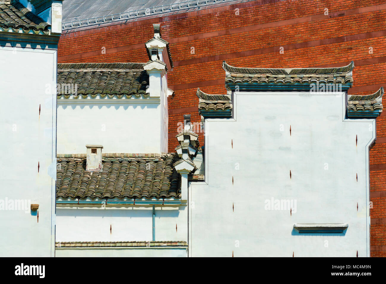An abstract image reflecting two cultural architecture styles, brick federal and asian.  The contrasting colors and textures makes it an interesting s Stock Photo