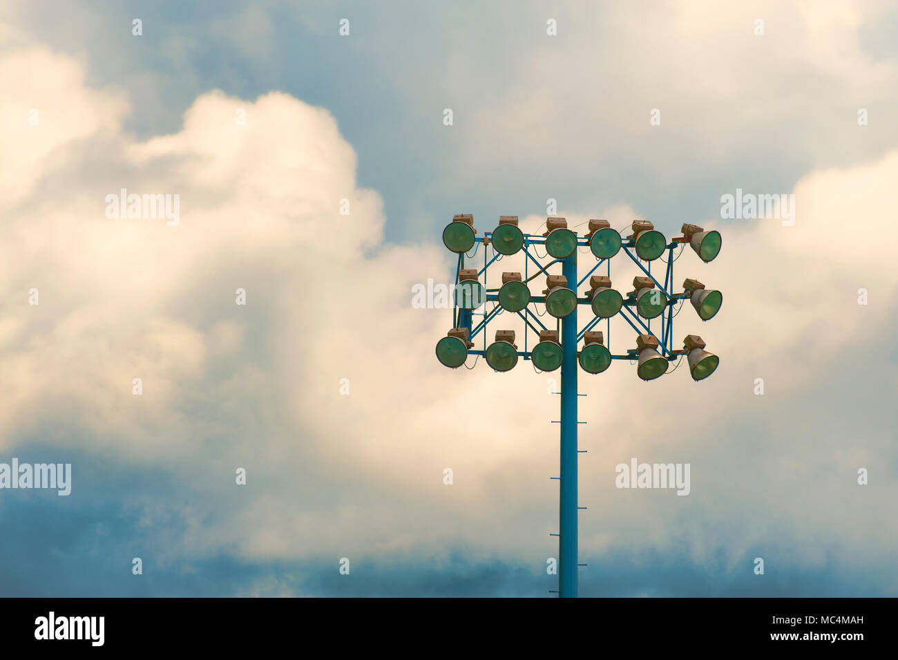 Minimalist of stadium lights against a cloudy sky Stock Photo