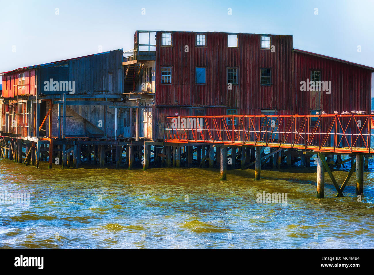 Astoria, Oregon, USA - May 30, 2014: A closeup of an old  old decaying red net loft along Astoria Oregon's waterfront on the Columbia River. Stock Photo