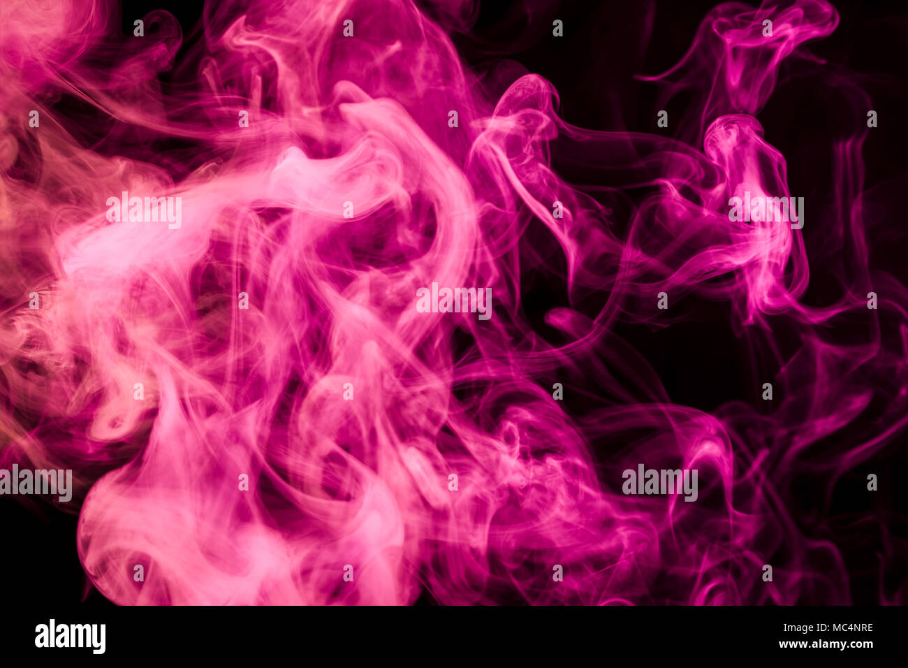 Pink smoke on black background Stock Photo - Alamy