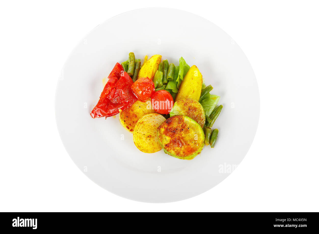 Vegetables grilled portion of side dish on a plate on white isolated background view from above. Appetizing dish for the menu restaurant, bar, cafe Stock Photo