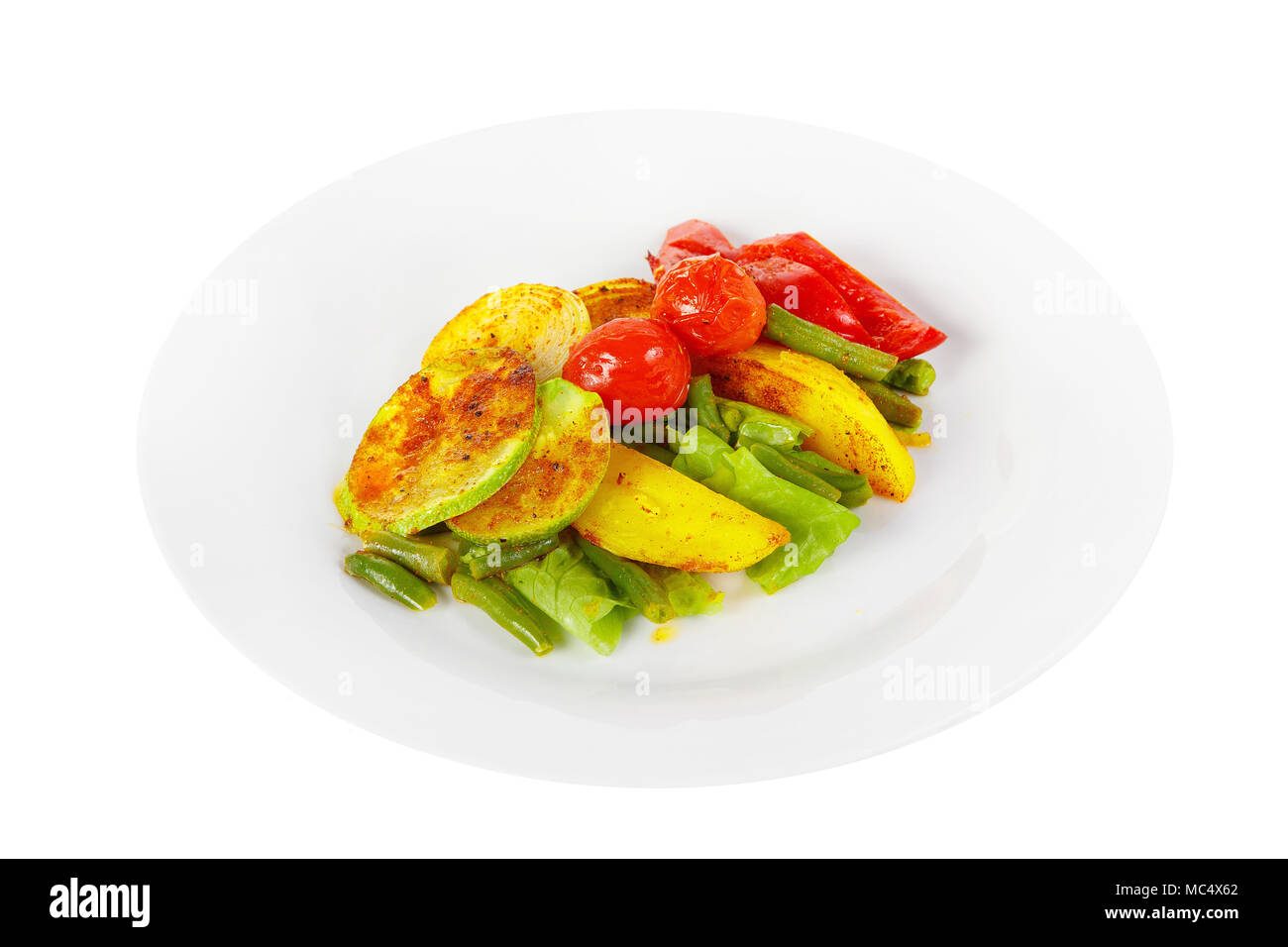 Vegetables grilled portion of side dish on a plate on white isolated background Side view. Appetizing dish for the menu restaurant, bar, cafe Stock Photo