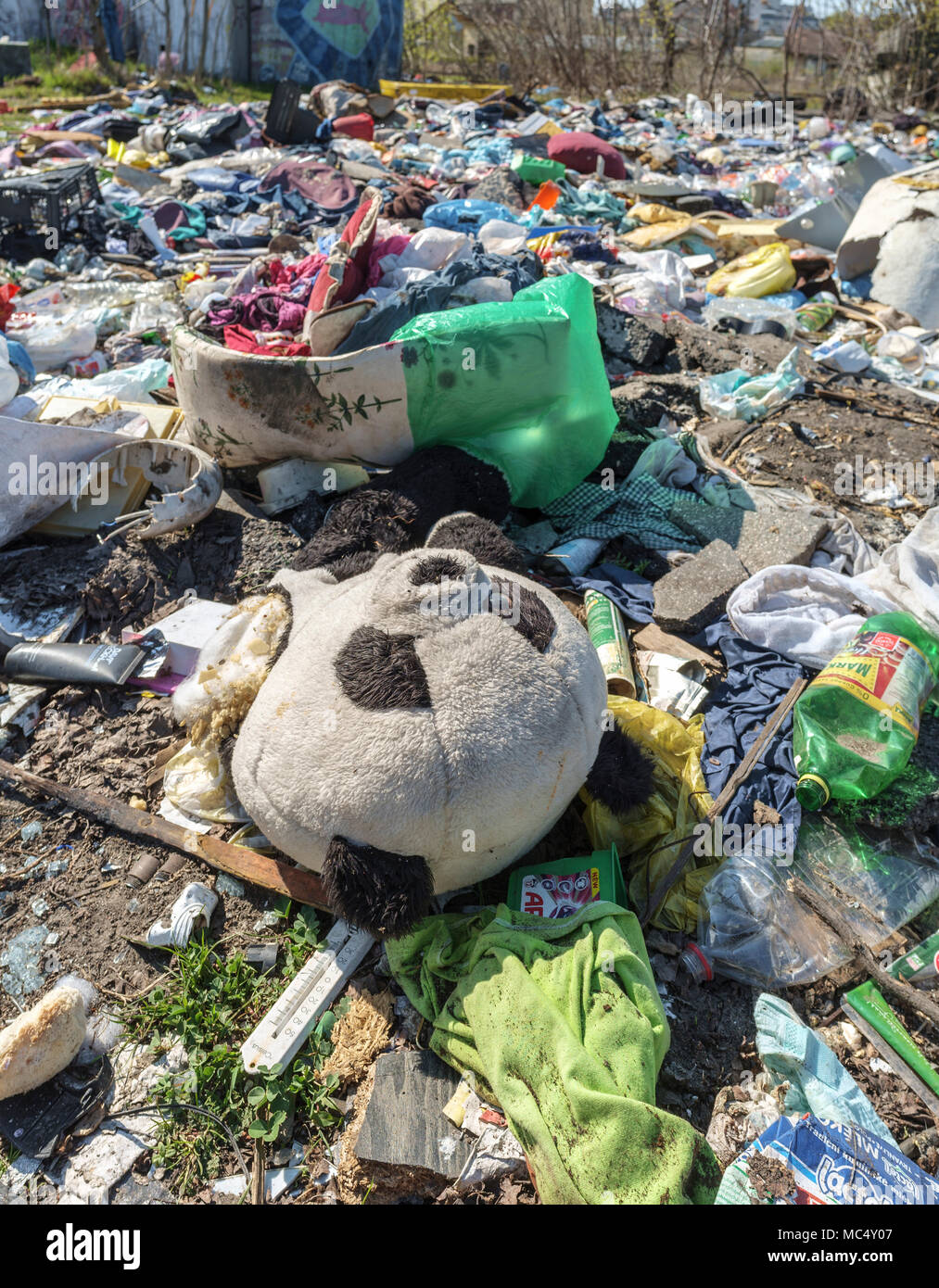 Old Panda teddy bear on the ground at a junkyard Stock Photo