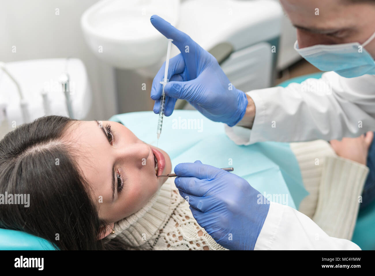 Female patient an injection of anesthesia in the mouth Stock Photo Alamy