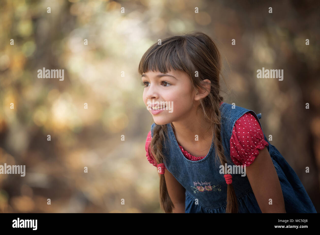 Cute Little Girl Playing In The Forest Stock Photo