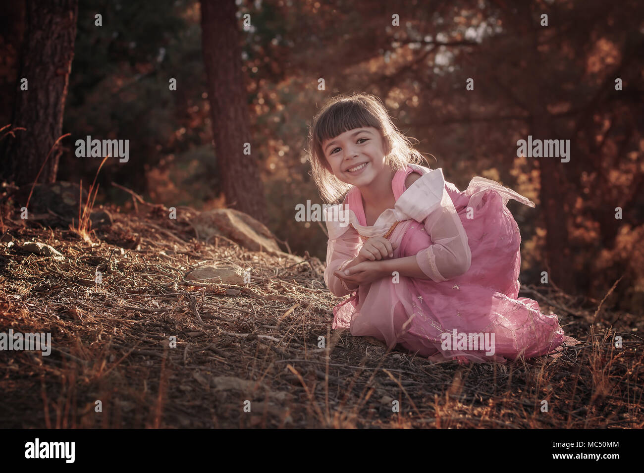 Cute Little Girl In The Forest Stock Photo