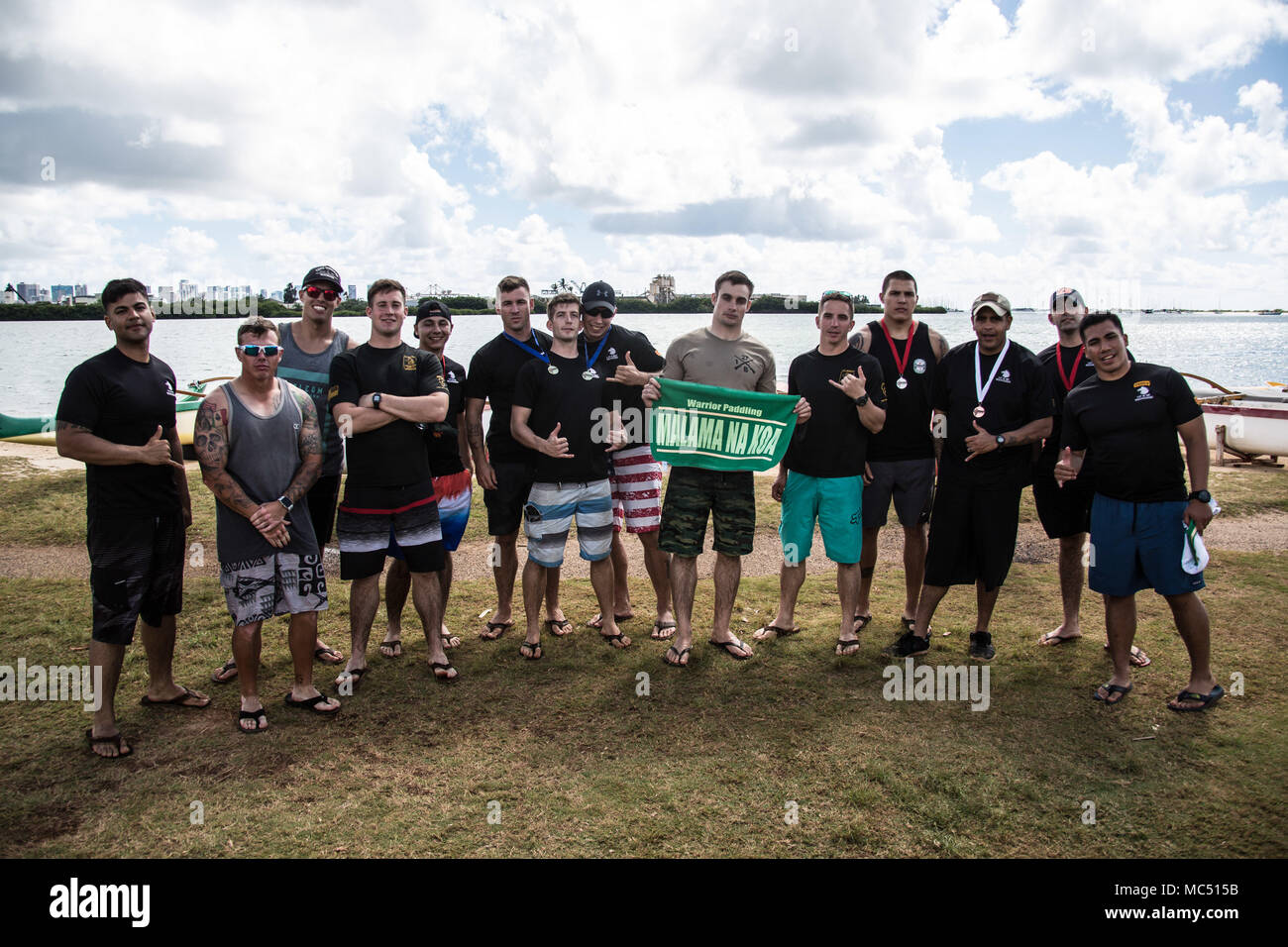 Participants from Borzoi Company, 1st Battalion, 27th Infantry Regiment, 2nd Infantry Brigade Combat Team, 25th Infantry Division pose for a group photo in Keehi Lagoon, Honolulu, Hi., Jan. 30, 2018. In an effort to strengthen international relationships, United States Army Pacific hosted personnel from the British Army to participate in a team building exercise facilitating outrigger canoeing. (U.S. Army photo by 1st. Lt. Ryan DeBooy) Stock Photo