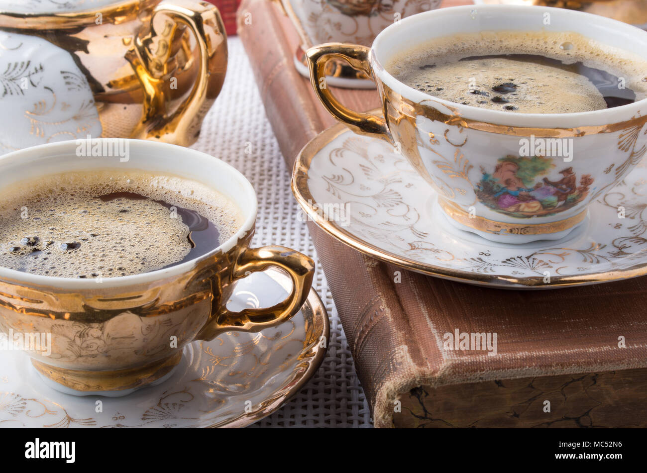Vintage coffee break. Antique porcelain coffee cups with hot coffee  close-up Stock Photo - Alamy