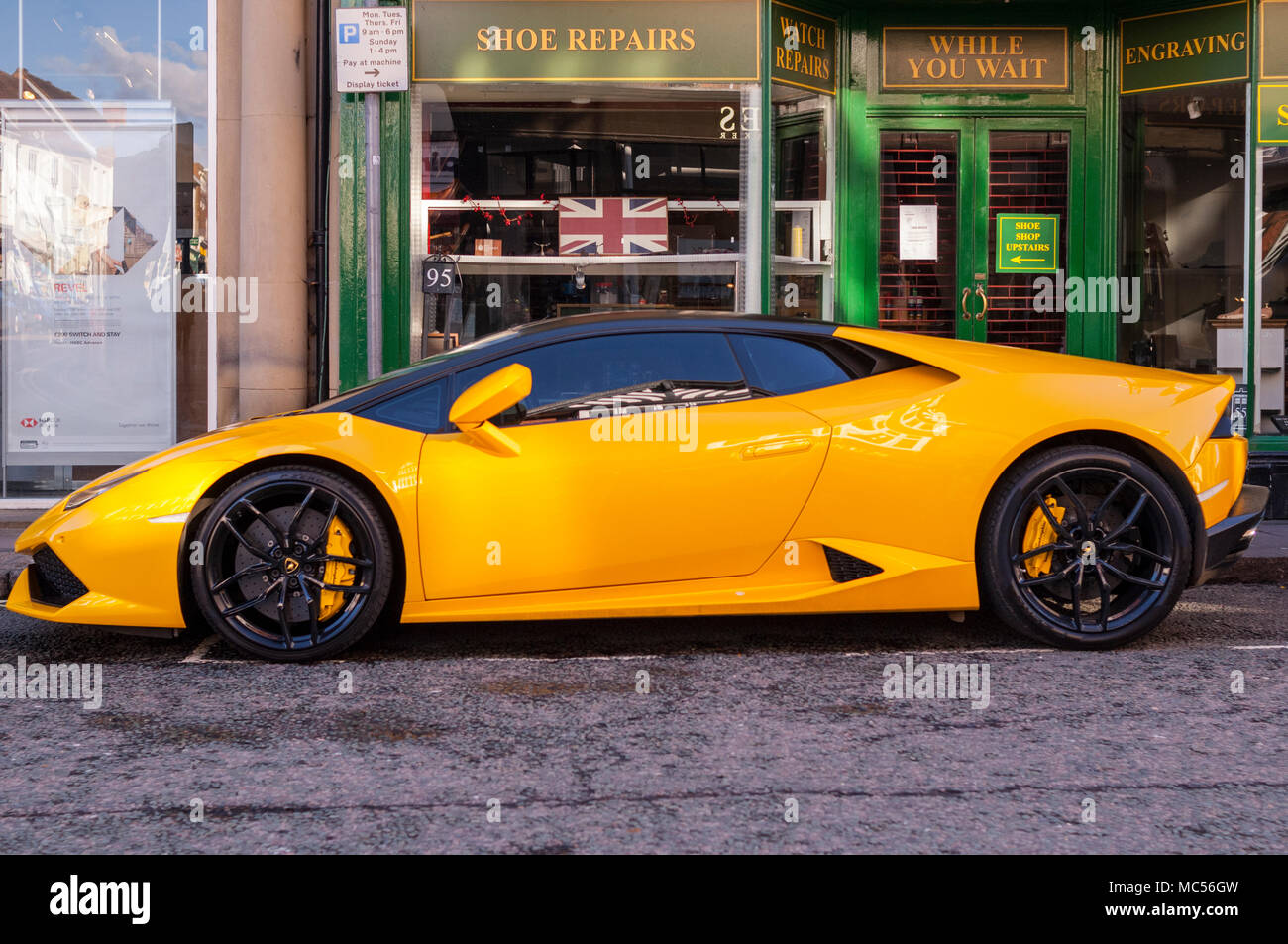 A yellow Lamborghini sports car in a uk street Stock Photo
