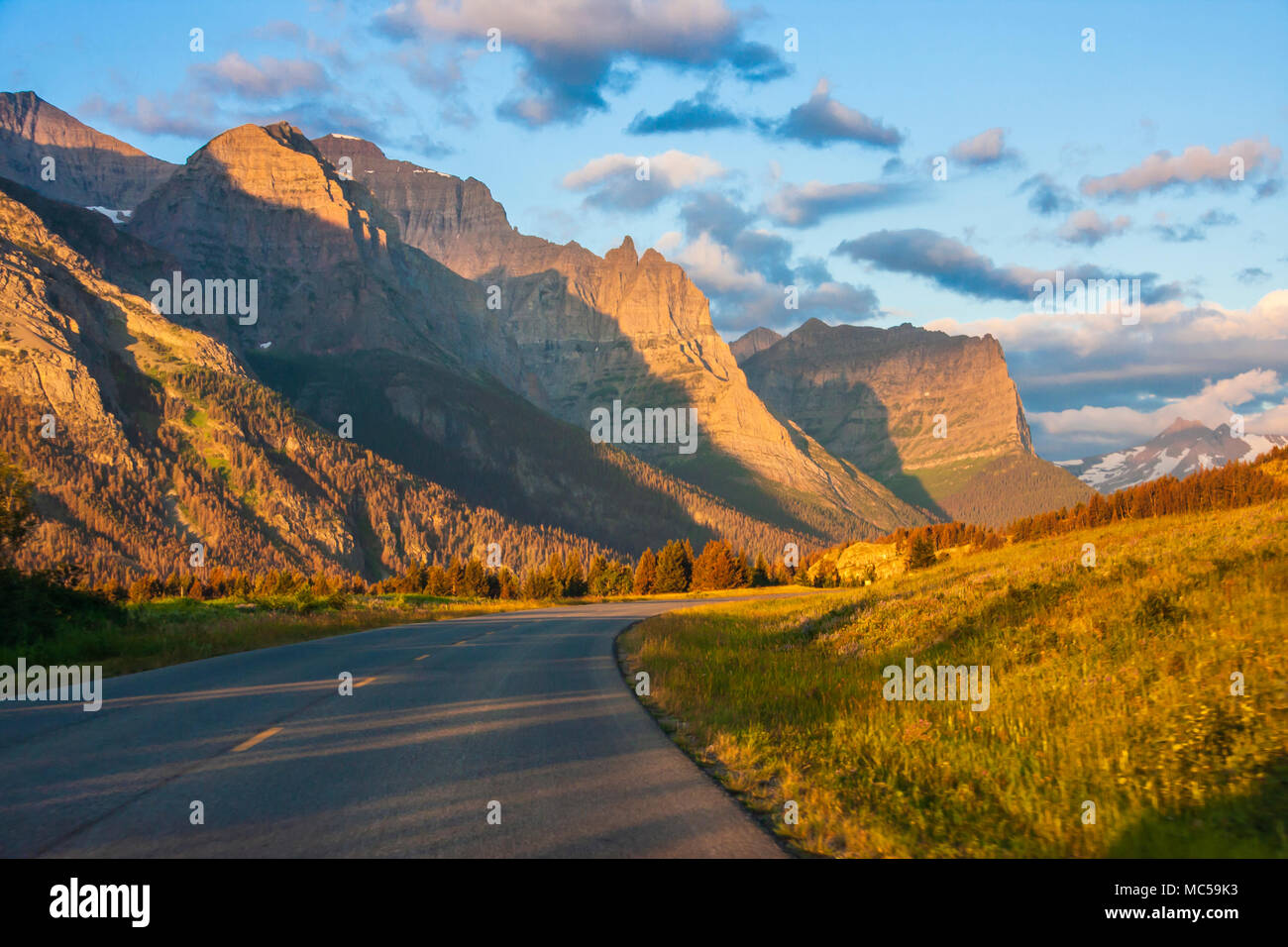 Sunrise lighting the mountains along Going to the Sun Road in Glacier National Park in Montana. Stock Photo
