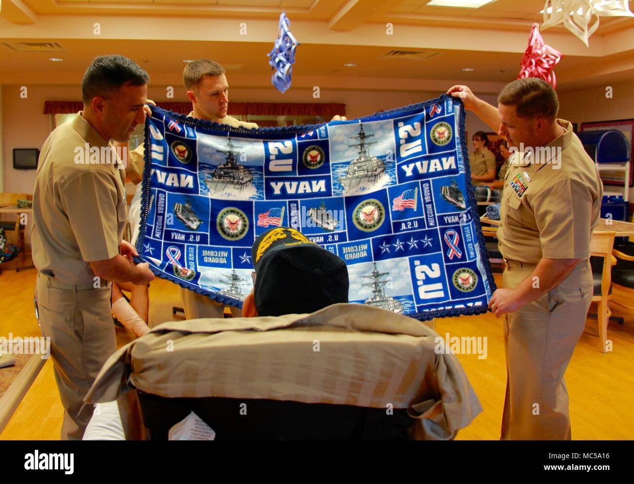 HONOLULU (Jan. 29, 2018) -- From left; Cmdr. Michael Salehi, Navy  Information Operations command Hawaii Executive Officer, Chief Cryptologic  Technician (Networks) Mitchell Sheppard, and Chief Cryptologic Technician  (Collection) Michael Koss present a