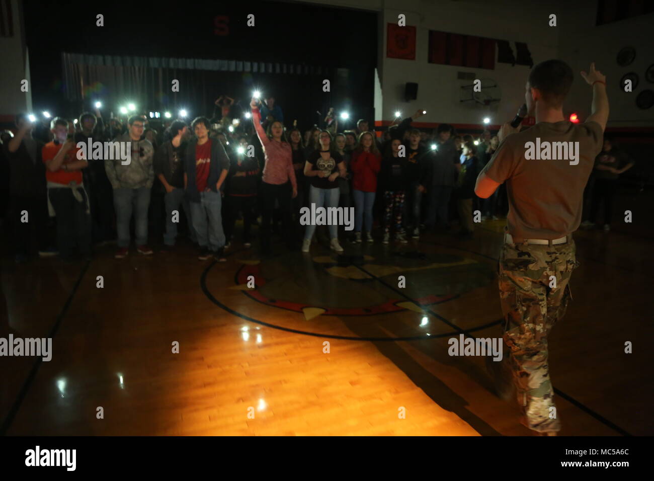 Students from Stover High School in Stover, MO raise their phones up